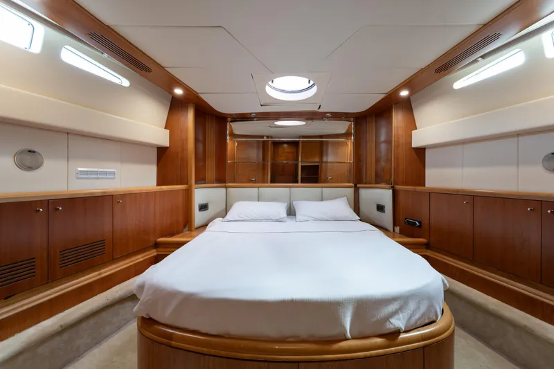 Senior S Yacht Photos Pics Luxurious bedroom interior of 2004 Azimut 80 yacht with elegant wood paneling.