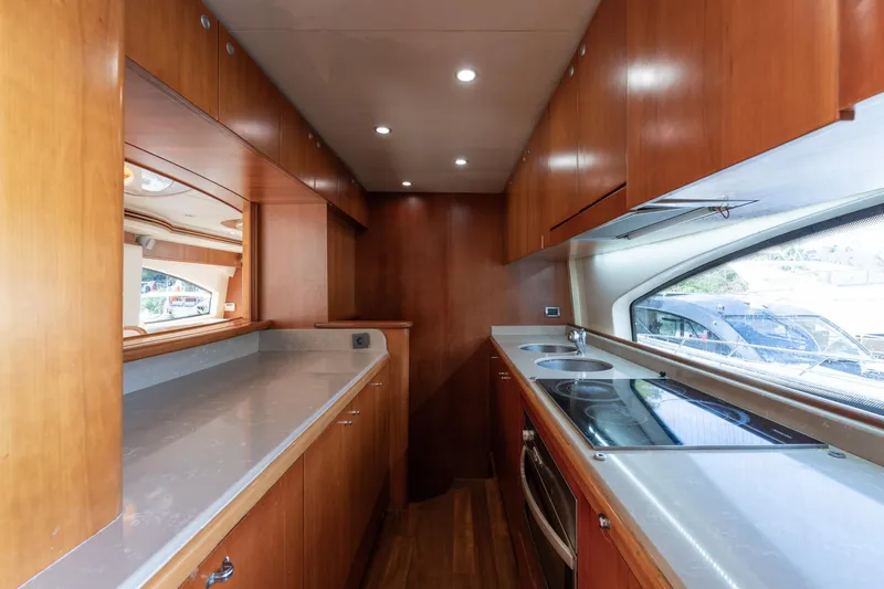 Senior S Yacht Photos Pics Luxurious kitchen interior of 2004 Azimut 80 yacht with modern appliances and wood cabinetry.