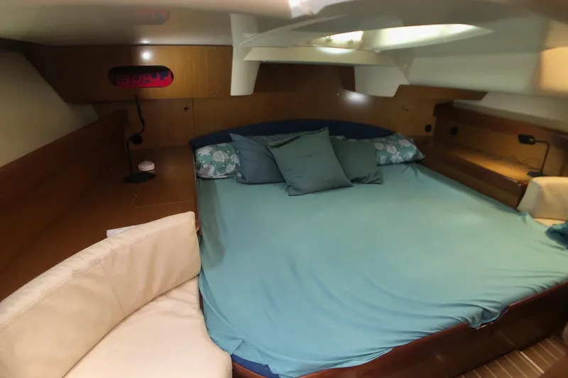 Marine Services S.a.s. Di Berruto Claudia Yacht Photos Pics Interior cabin of 2006 Jeanneau Sun Odyssey 42 DS with cozy bedding and seating.