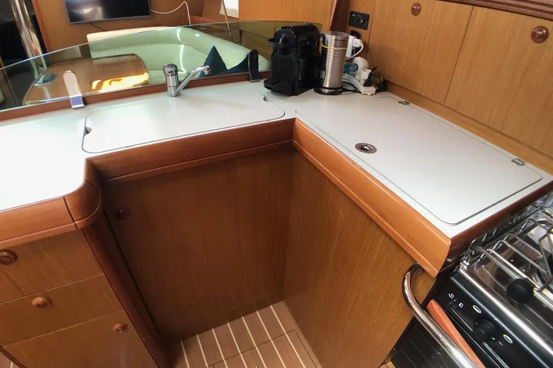 Marine Services S.a.s. Di Berruto Claudia Yacht Photos Pics 2006 Jeanneau Sun Odyssey 42 DS yacht kitchen with sink, stove, and coffee maker.