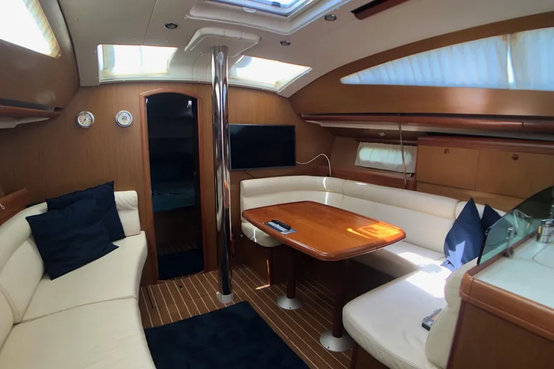 Marine Services S.a.s. Di Berruto Claudia Yacht Photos Pics Interior of 2006 Jeanneau Sun Odyssey 42 DS yacht with elegant seating and wooden table.