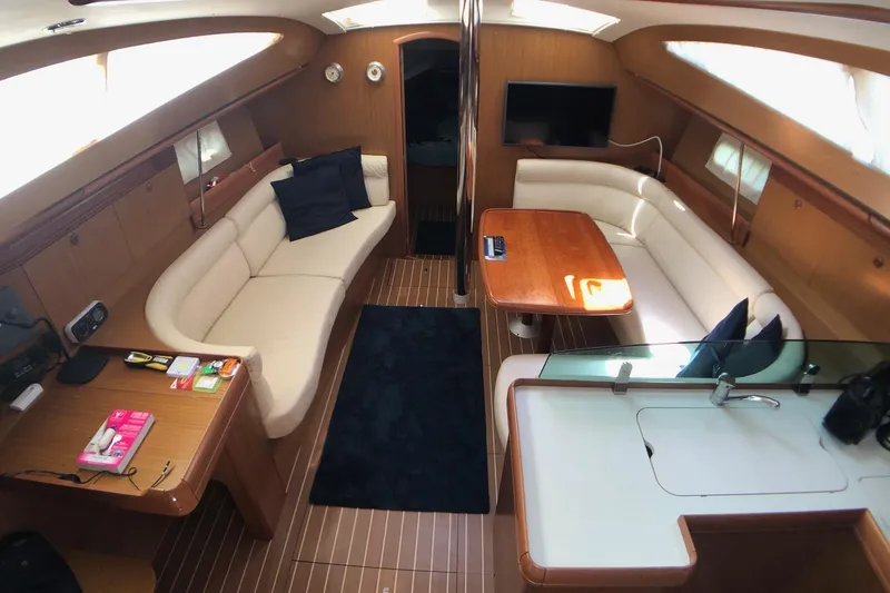 Marine Services S.a.s. Di Berruto Claudia Yacht Photos Pics Luxurious interior of 2006 Jeanneau Sun Odyssey 42 DS sailboat with elegant seating and dining area.