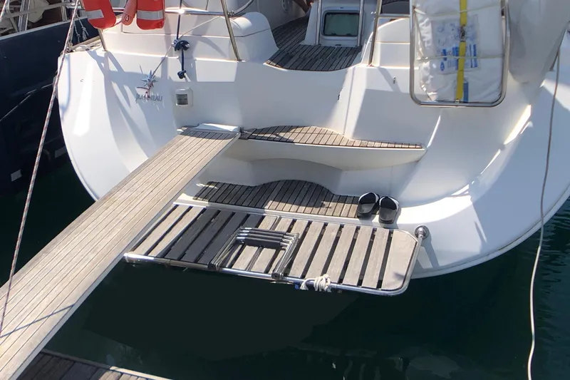Marine Services S.a.s. Di Berruto Claudia Yacht Photos Pics Jeanneau Sun Odyssey 42 DS yacht stern with wooden deck and boarding platform, 2006 model.
