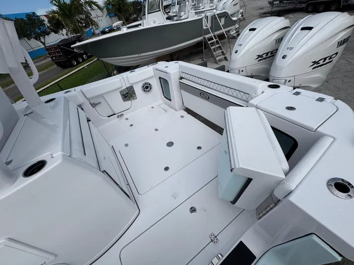  Yacht Photos Pics 2025 Sportsman Open 322 Center Console boat interior with Yamaha engines, docked outdoors.