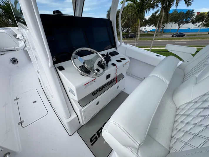  Yacht Photos Pics 2025 Sportsman Open 322 Center Console boat interior with steering wheel and seating.