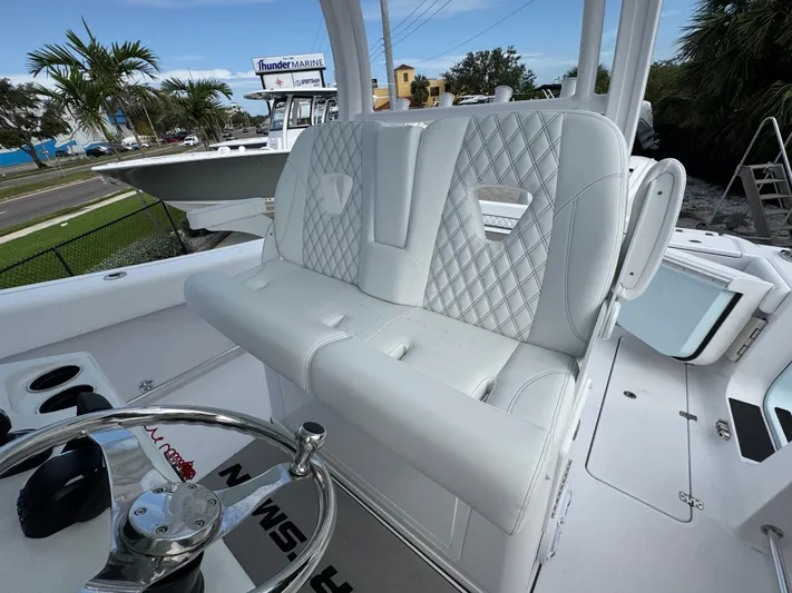  Yacht Photos Pics 2025 Sportsman Open 322 Center Console boat with white seating and steering wheel.