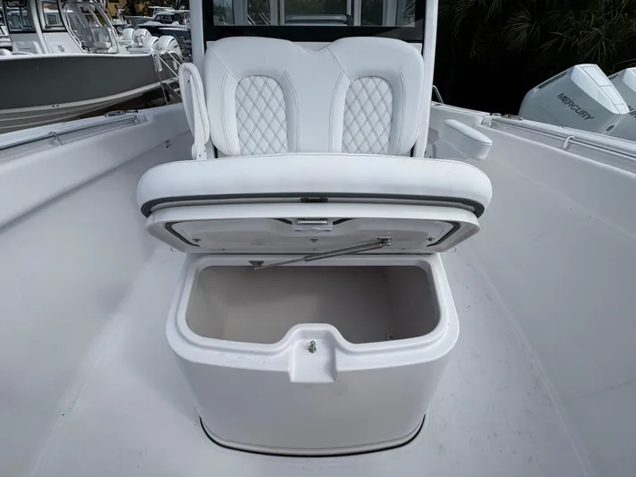  Yacht Photos Pics 2025 Sportsman Open 322 Center Console boat with open storage compartment and cushioned seating.