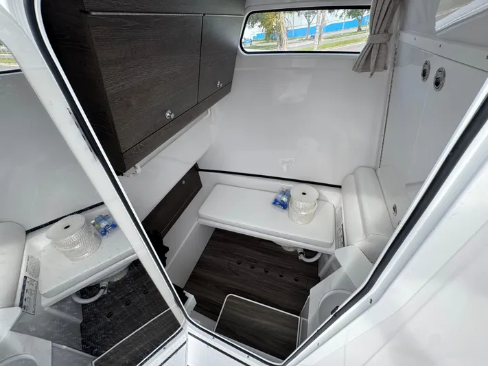  Yacht Photos Pics Interior cabin of 2025 Sportsman Open 322 Center Console boat, featuring storage and seating.