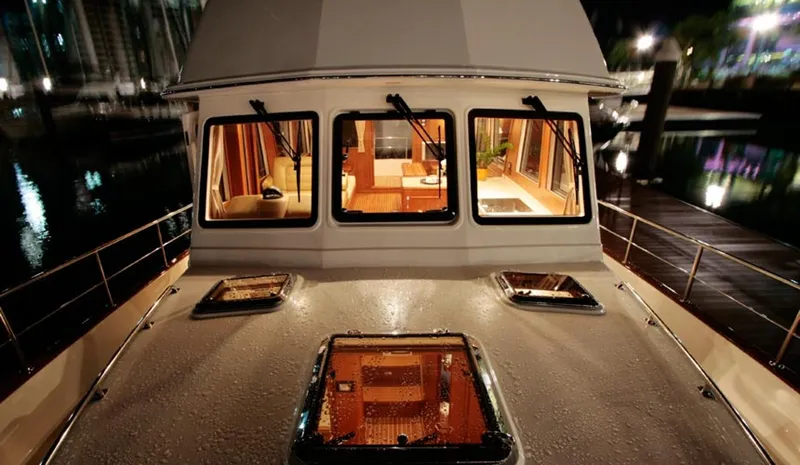 Hop Aboard Yacht Photos Pics 2015 Grand Banks 43 Heritage EU yacht at night, interior lights on.