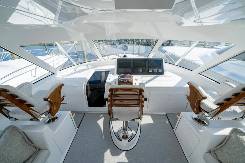 Pamela Yacht Photos Pics 2024 Viking 48 Sport Tower yacht interior with modern helm and luxurious seating.
