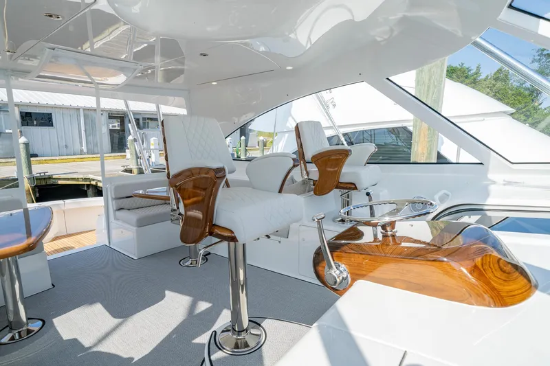 Pamela Yacht Photos Pics Luxurious interior of 2024 Viking 48 Sport Tower yacht with elegant seating and polished wood accents.
