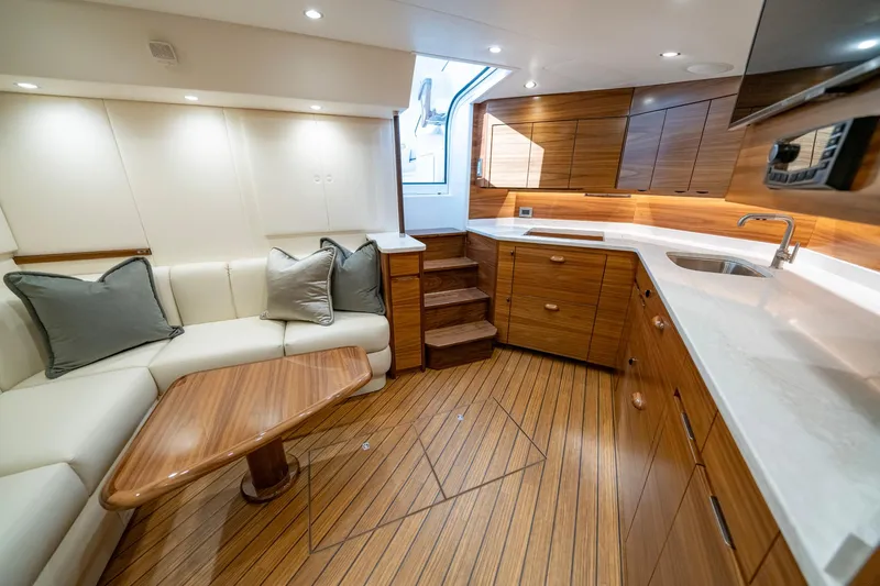 Pamela Yacht Photos Pics Luxurious interior of 2024 Viking 48 Sport Tower yacht with wood accents and modern design.