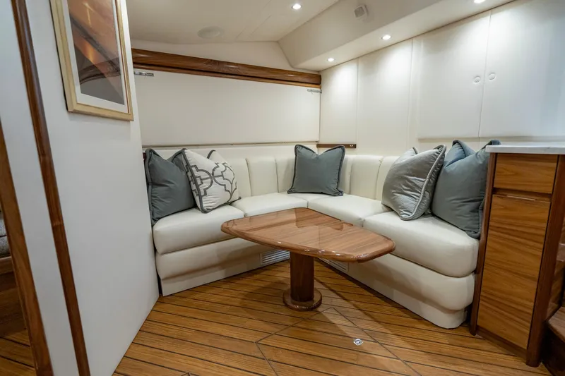 Pamela Yacht Photos Pics 2024 Viking 48 Sport Tower interior with elegant seating and wooden table.