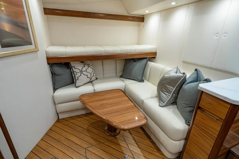 Pamela Yacht Photos Pics 2024 Viking 48 Sport Tower interior with elegant seating and wooden table.