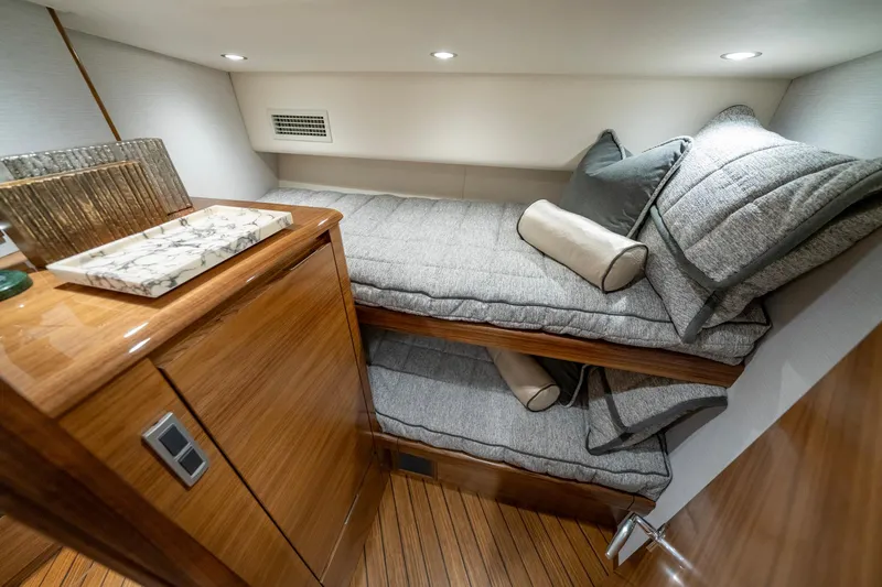 Pamela Yacht Photos Pics 2024 Viking 48 Sport Tower cabin with cozy twin beds and wooden cabinetry.