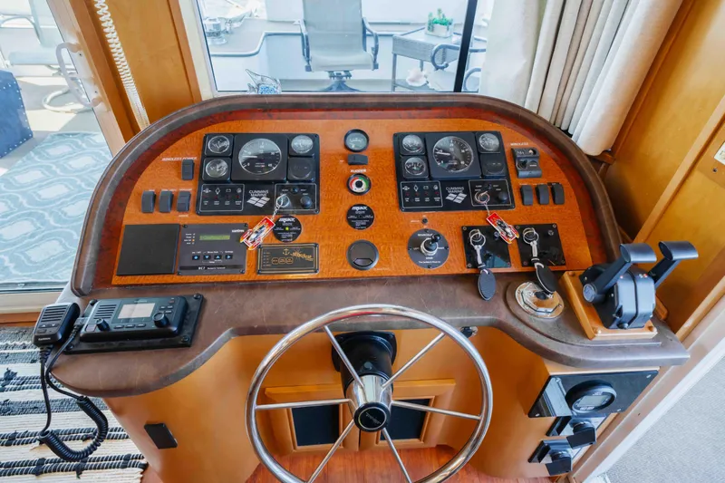  Yacht Photos Pics Control panel of a 2004 Stardust Cruisers houseboat with steering wheel and gauges.