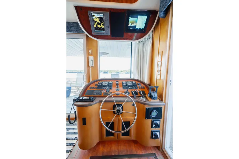  Yacht Photos Pics 2004 Stardust Cruisers houseboat helm with steering wheel and navigation equipment.