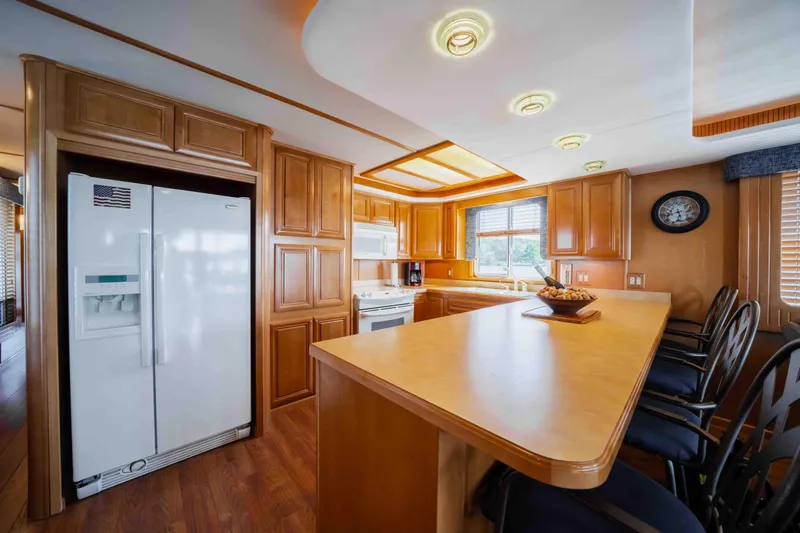  Yacht Photos Pics Luxurious 2004 Stardust Cruisers houseboat kitchen with wooden cabinets and modern appliances.