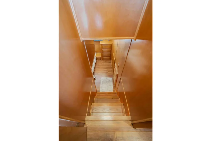  Yacht Photos Pics Wooden staircase inside a 2004 Stardust Cruisers houseboat, leading to a cozy interior space.