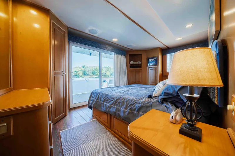  Yacht Photos Pics Luxurious 2004 Stardust Cruisers houseboat bedroom with scenic water view and elegant wooden furnishings.