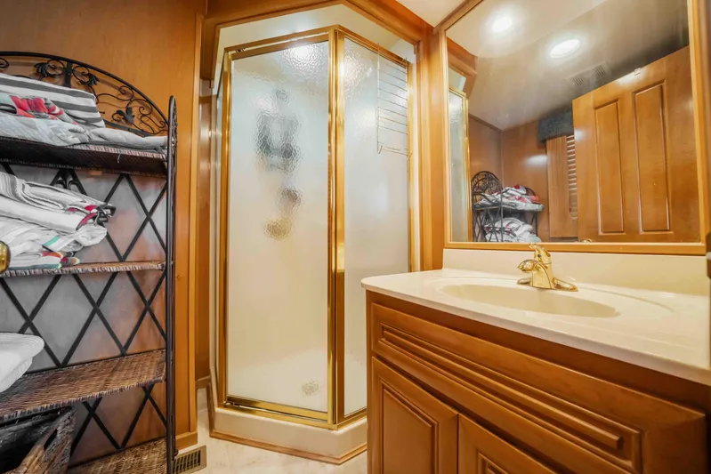  Yacht Photos Pics Luxurious 2004 Stardust Cruisers houseboat bathroom with shower, vanity, and towel storage.