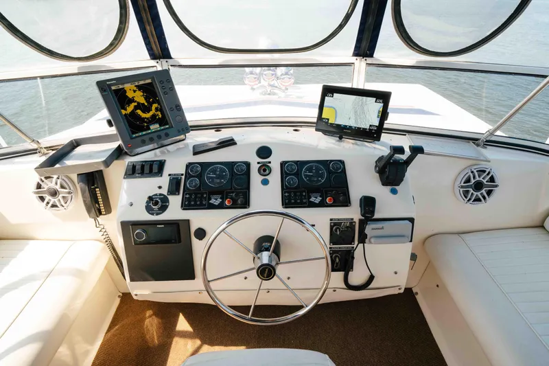  Yacht Photos Pics 2004 Stardust Cruisers houseboat helm with navigation equipment and steering wheel.