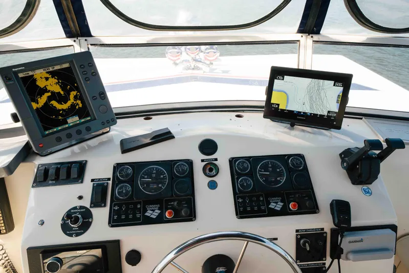  Yacht Photos Pics Control panel of a 2004 Stardust Cruisers houseboat with navigation screens and gauges.