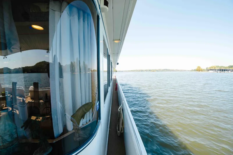  Yacht Photos Pics 2004 Stardust Cruisers houseboat on serene lake with scenic view.