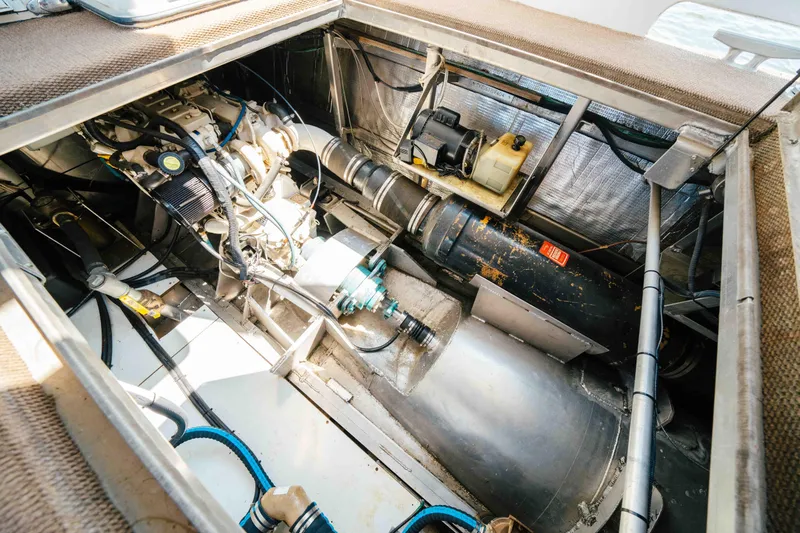  Yacht Photos Pics Engine compartment of a 2004 Stardust Cruisers houseboat, showcasing mechanical components and wiring.