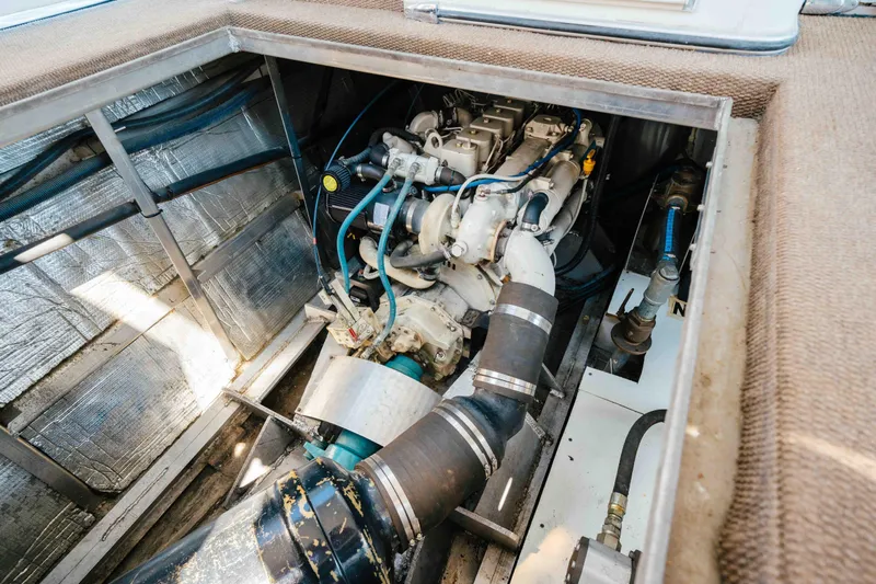  Yacht Photos Pics Engine compartment of a 2004 Stardust Cruisers houseboat, showcasing mechanical components.