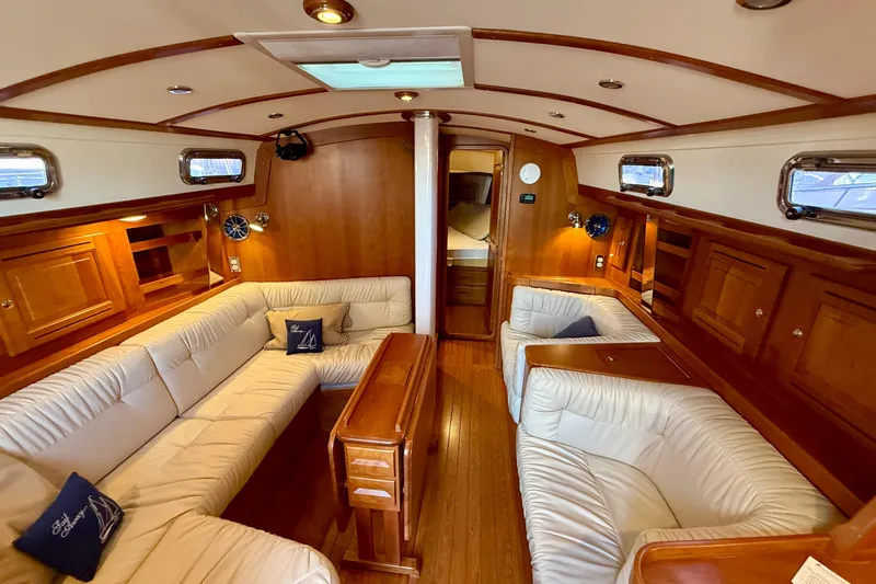 Tangaroa Yacht Photos Pics Luxurious interior of 2015 Tartan 4000 yacht with elegant wood finish and plush seating.