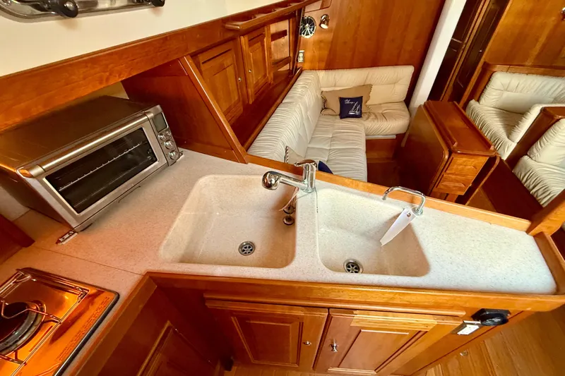 Tangaroa Yacht Photos Pics Luxurious Tartan 4000 yacht interior with kitchen and seating area, 2015 model.