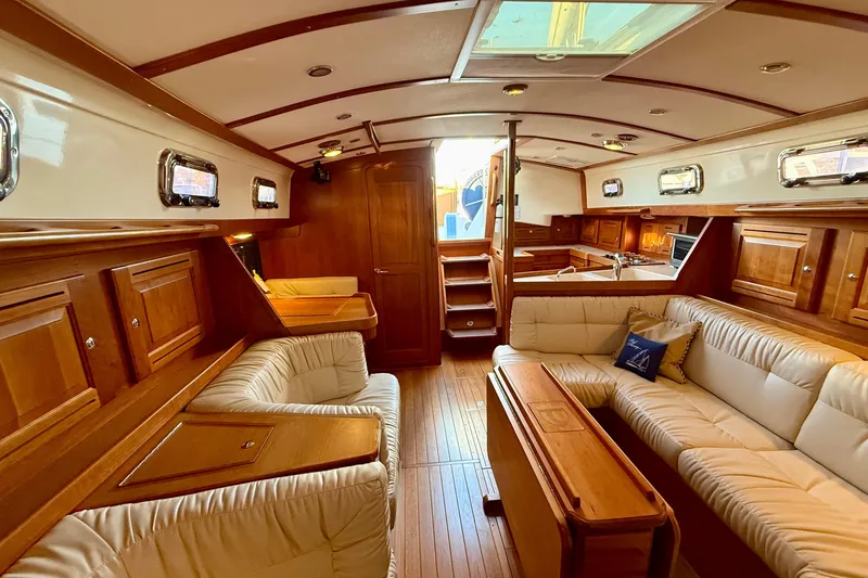Tangaroa Yacht Photos Pics Luxurious interior of 2015 Tartan 4000 yacht with elegant wood finish and plush seating.
