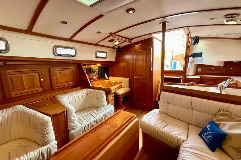 Tangaroa Yacht Photos Pics Luxurious interior of 2015 Tartan 4000 yacht with elegant wood finish and plush seating.
