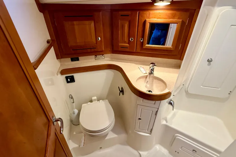 Tangaroa Yacht Photos Pics 2015 Tartan 4000 yacht bathroom with wooden cabinets and modern fixtures.