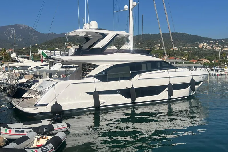  Yacht Photos Pics 2025 Ferretti Yachts 670 docked in a scenic marina with mountains in the background.