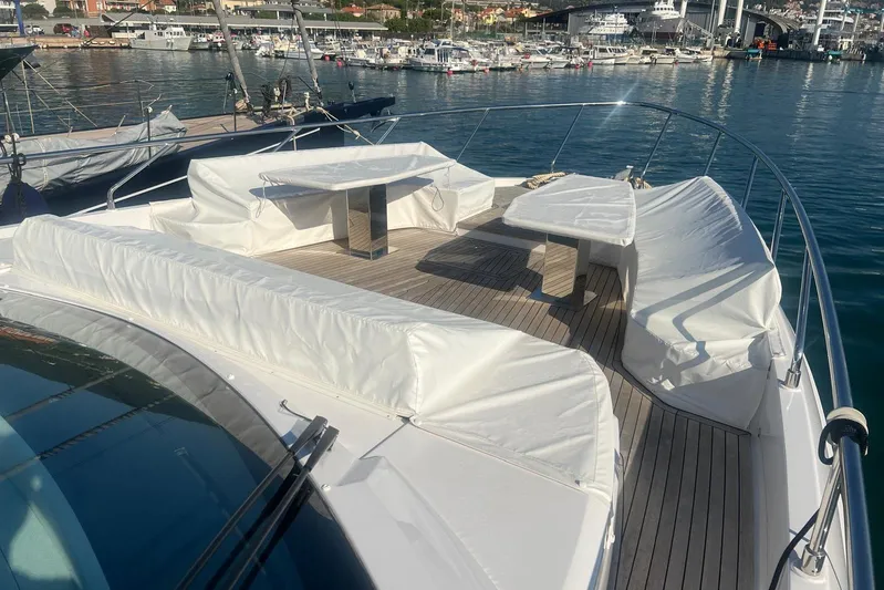  Yacht Photos Pics Luxurious 2025 Ferretti Yachts 670 with spacious deck seating in a marina setting.