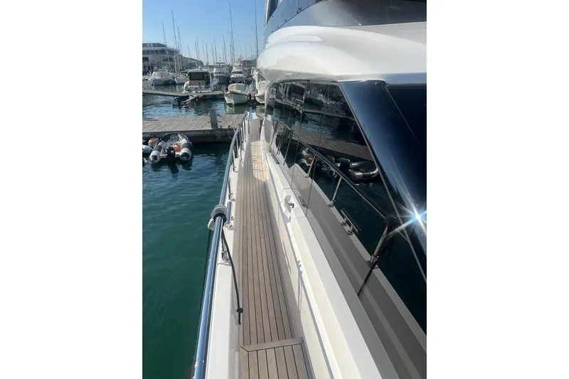  Yacht Photos Pics 2025 Ferretti Yachts 670 docked, showcasing sleek design and luxurious deck.