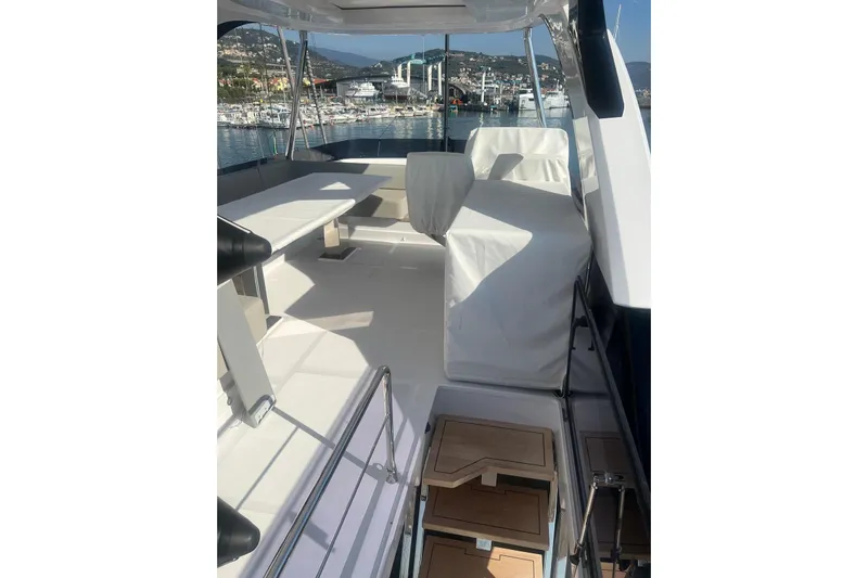  Yacht Photos Pics Luxurious 2025 Ferretti Yachts 670 deck with marina view, featuring sleek design and seating.