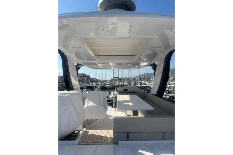  Yacht Photos Pics Luxurious 2025 Ferretti Yachts 670 interior with elegant seating and marina view.