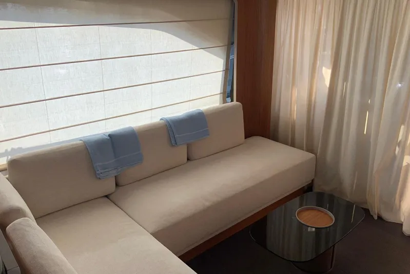  Yacht Photos Pics Luxurious interior of 2025 Ferretti Yachts 670 with elegant beige sofa and modern table.