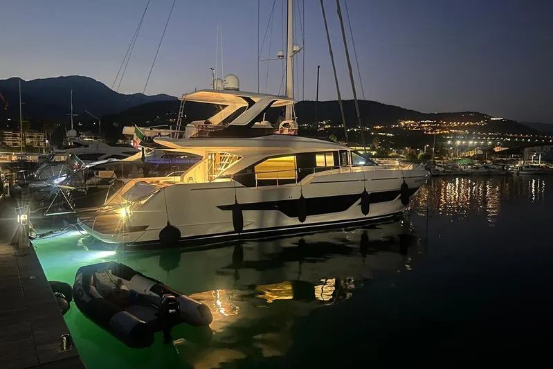  Yacht Photos Pics Luxurious 2025 Ferretti Yachts 670 docked at night, illuminated in serene marina.
