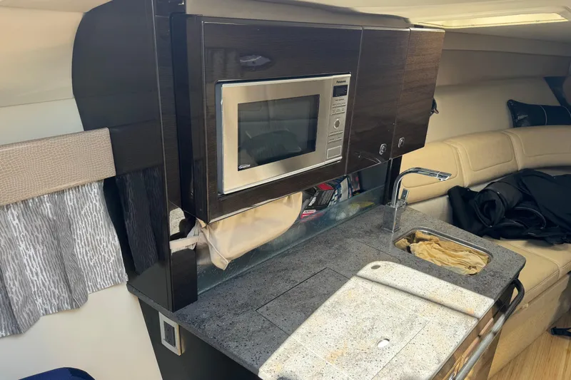  Yacht Photos Pics 2014 Formula 350 Sun Sport interior with kitchenette, microwave, and sink.