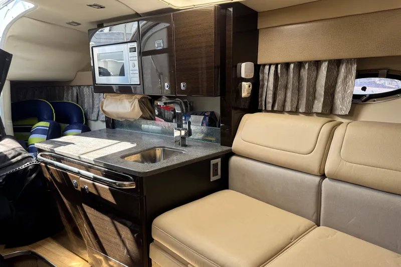  Yacht Photos Pics Interior of 2014 Formula 350 Sun Sport boat with kitchenette and seating area.