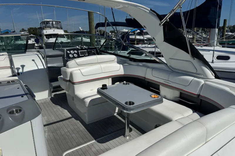  Yacht Photos Pics 2014 Formula 350 Sun Sport boat interior with white seating and table, docked at marina.