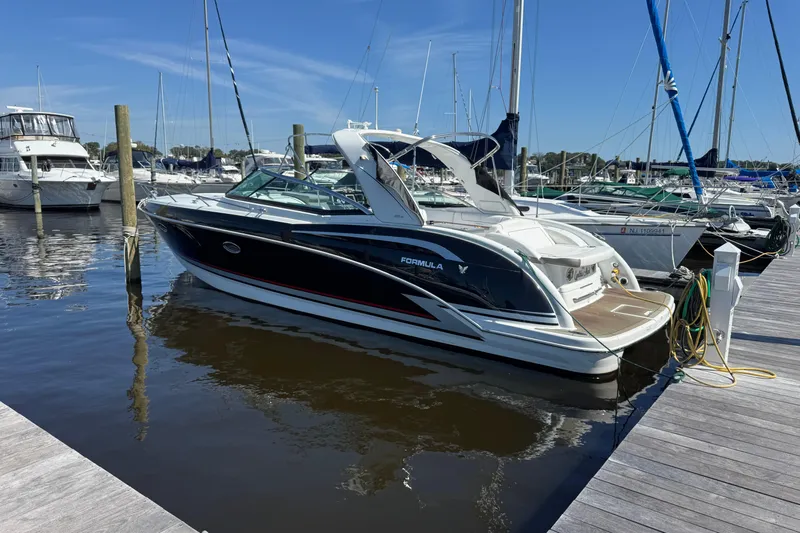  Yacht Photos Pics 2014 Formula 350 Sun Sport boat docked at a marina under clear blue skies.