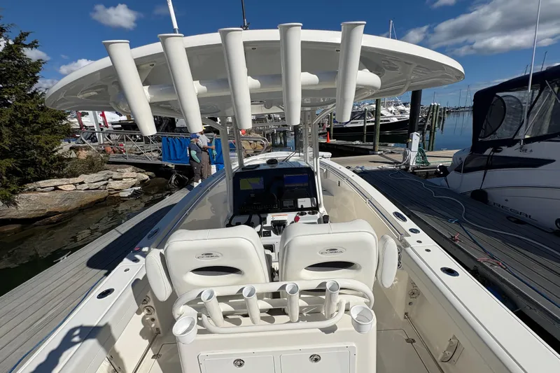  Yacht Photos Pics 2022 Cobia 280 Center Console boat docked at marina, featuring spacious seating and rod holders.