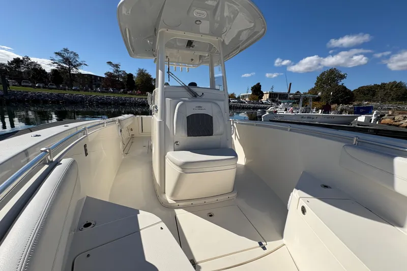  Yacht Photos Pics 2022 Cobia 280 Center Console boat docked, showcasing spacious seating and helm.