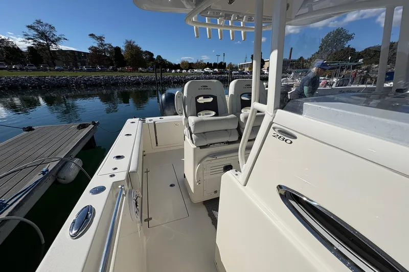  Yacht Photos Pics 2022 Cobia 280 Center Console boat docked at marina, showcasing seating and console.
