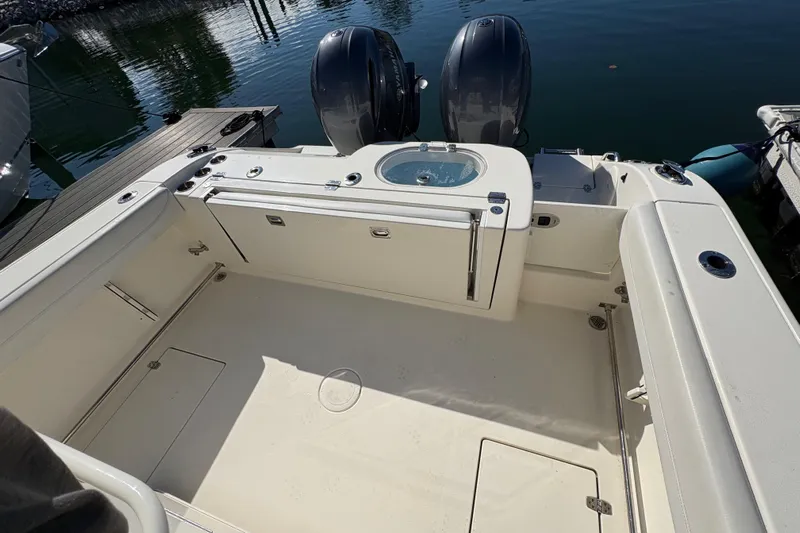  Yacht Photos Pics 2022 Cobia 280 Center Console boat deck with twin engines, docked at marina.